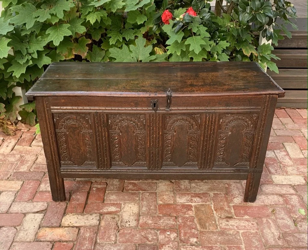 Early oak coffer c.1660 four-panel carved front straight stile legs plain lower rail iron escutcheon