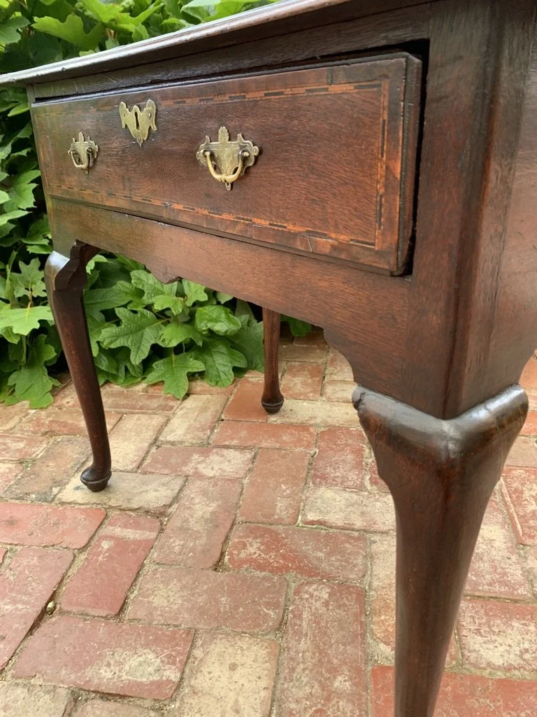 close up view of drawer front and period brass handles of georgian oak side table