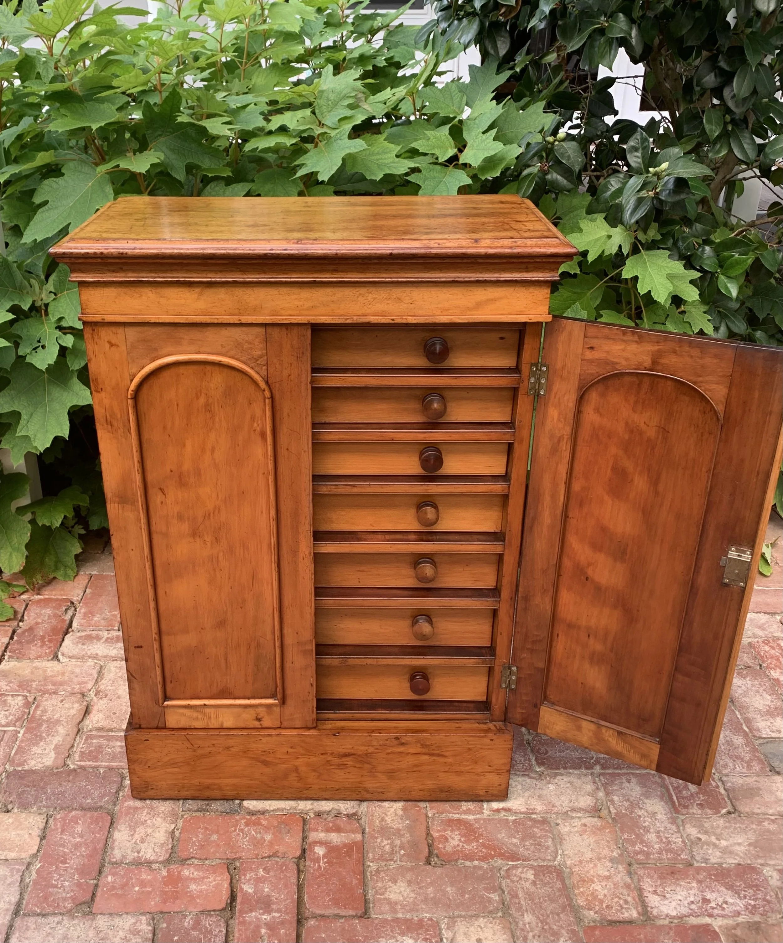 front view with one door open of 19th century collector's chest 
