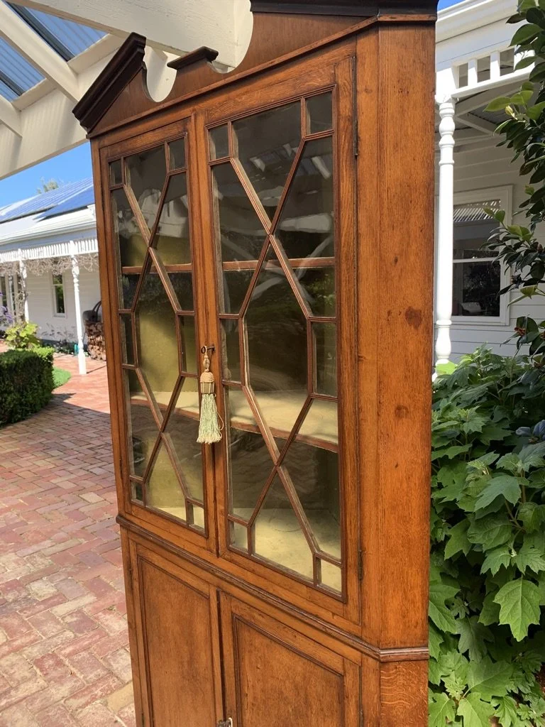 side view of top section and architectural pediment of Georgian oak corner cabinet