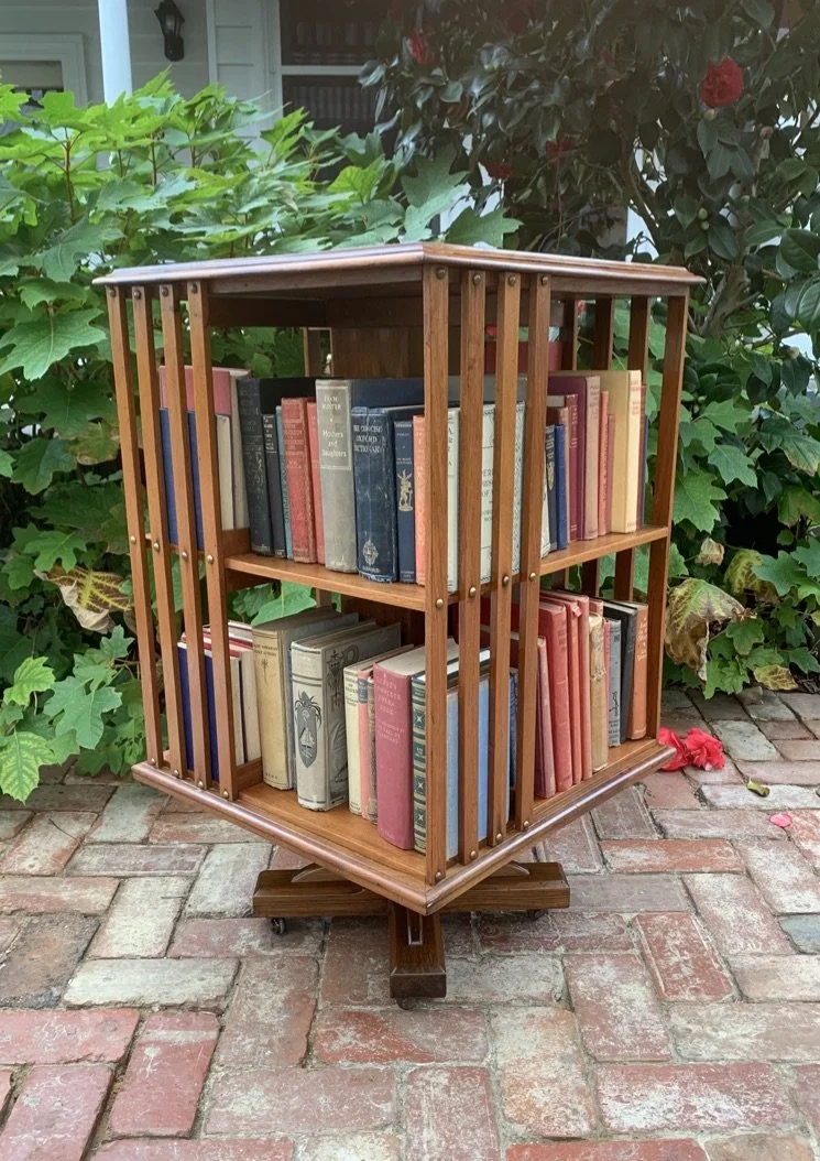 Edwardian walnut two-tier revolving bookcase c.1910 brass stud uprights full view