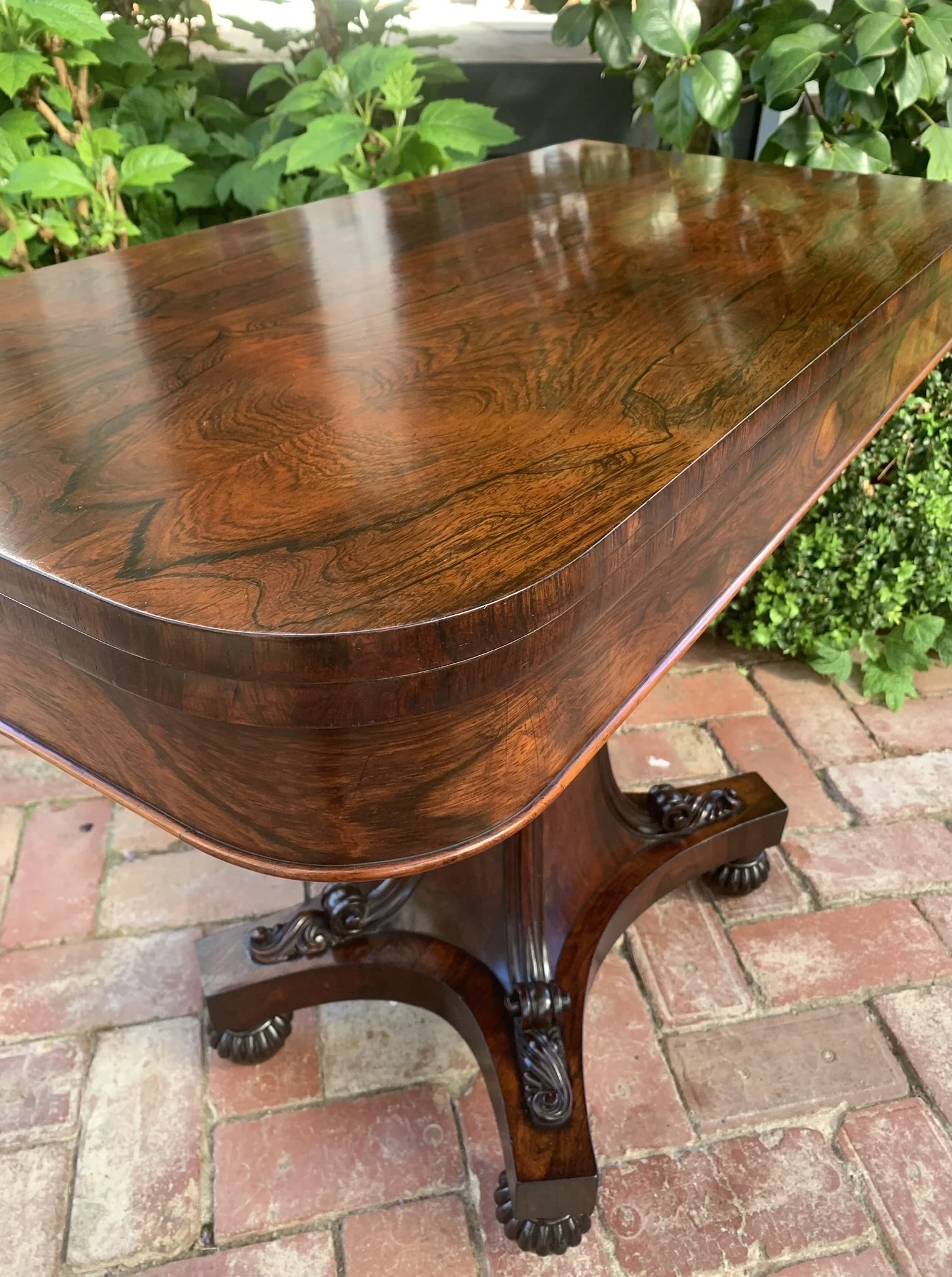 Close-up of rosewood grain and reeded column on antique card table