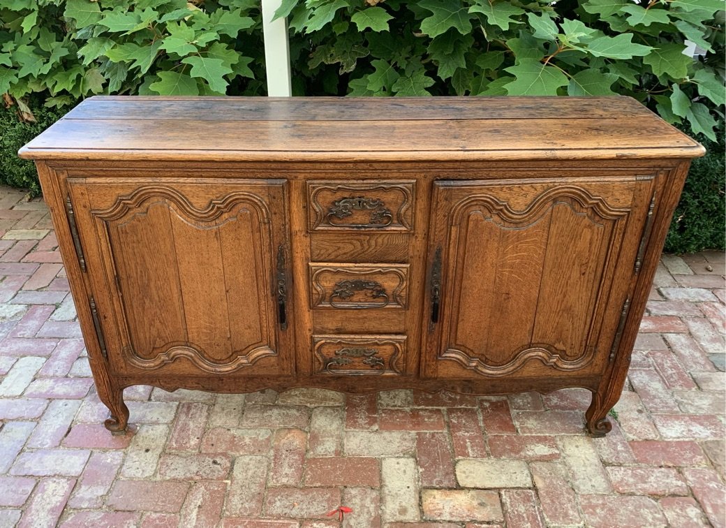 18th-century French oak enfilade front view, shaped panel doors, serpentine apron, warm honey patina