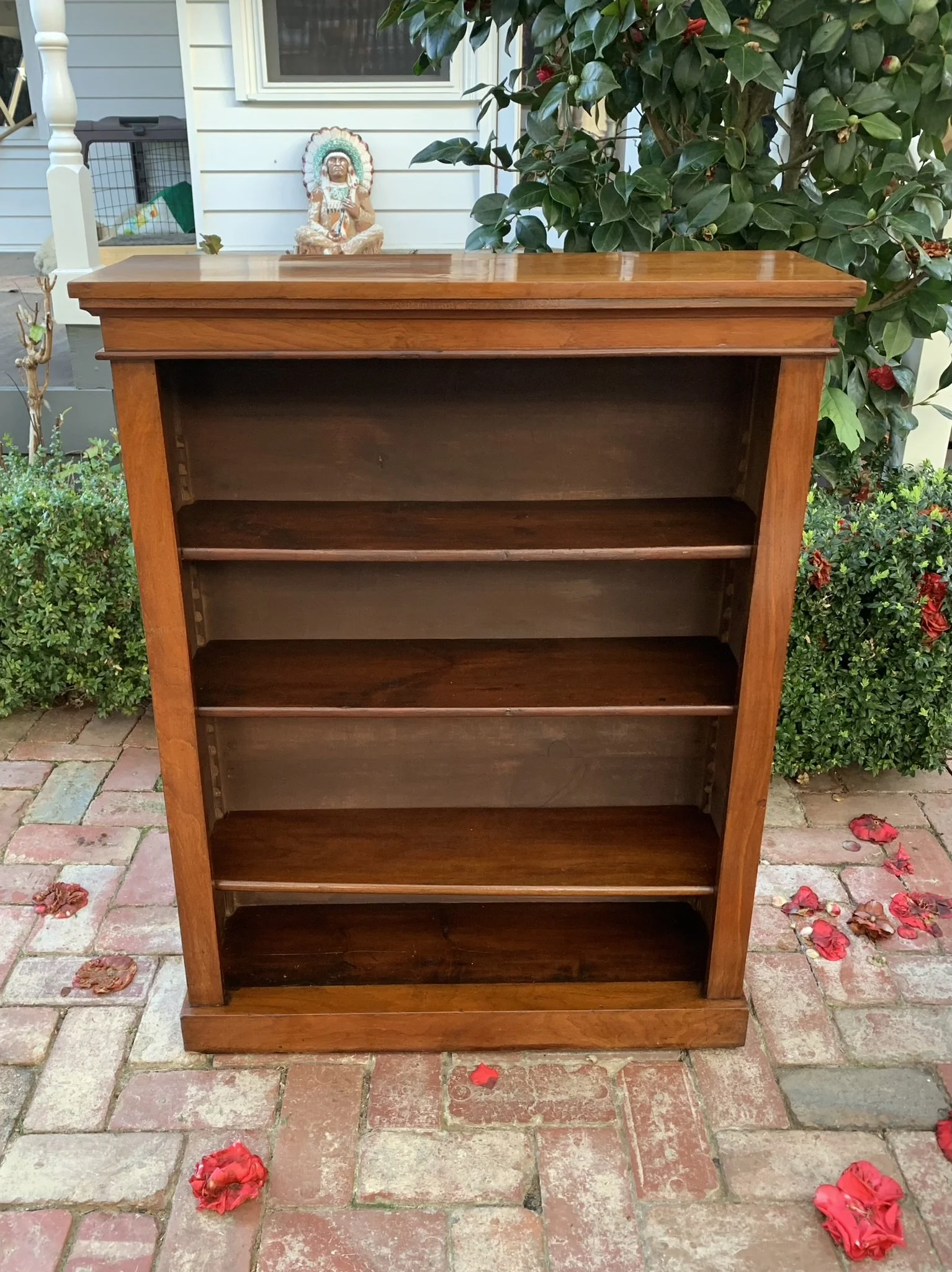 Antique Victorian walnut bookcase interior showing adjustable shelf pegs, open freestanding library shelf unit