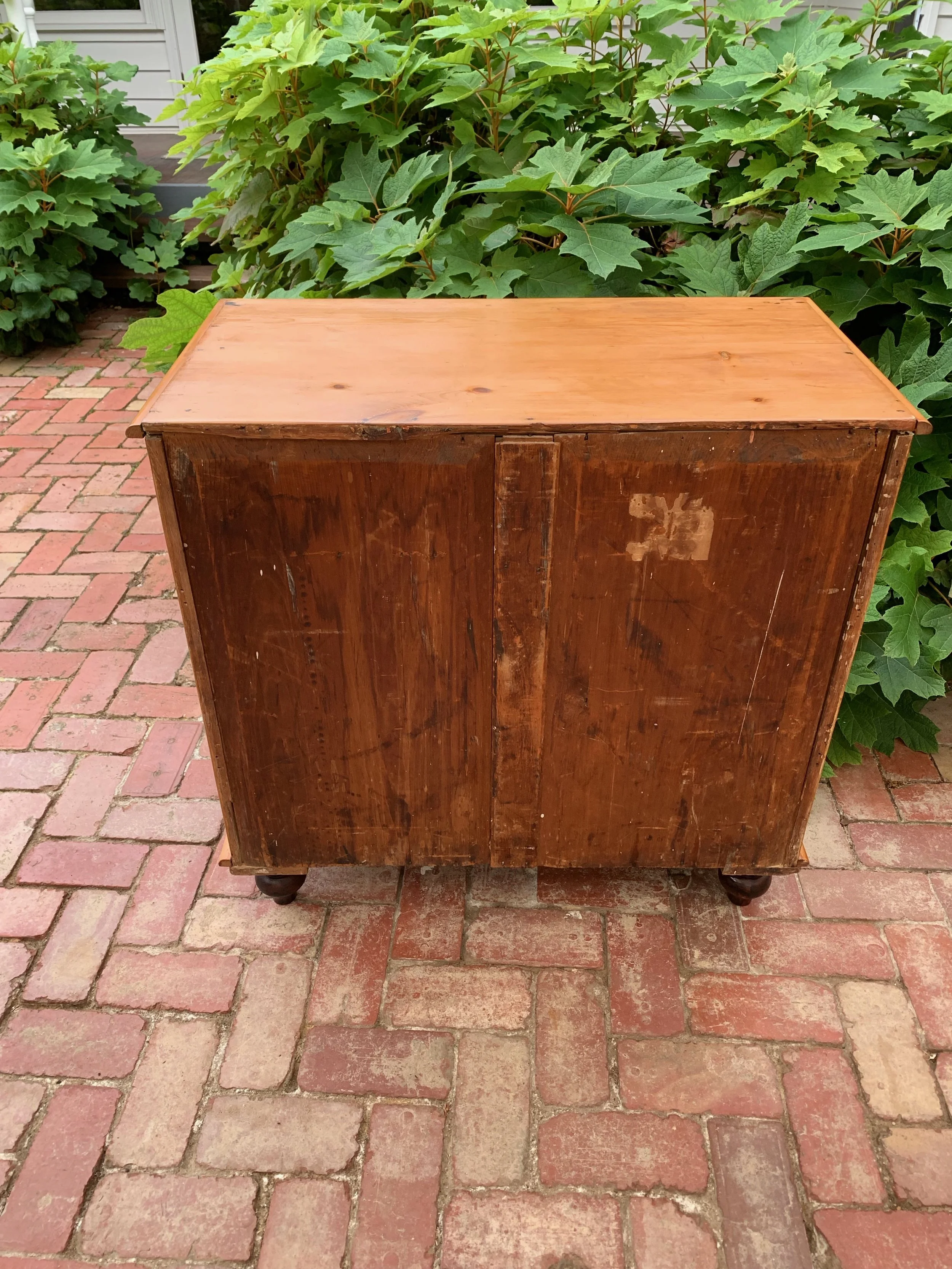 View of back of 19th century country pine chest of drawers