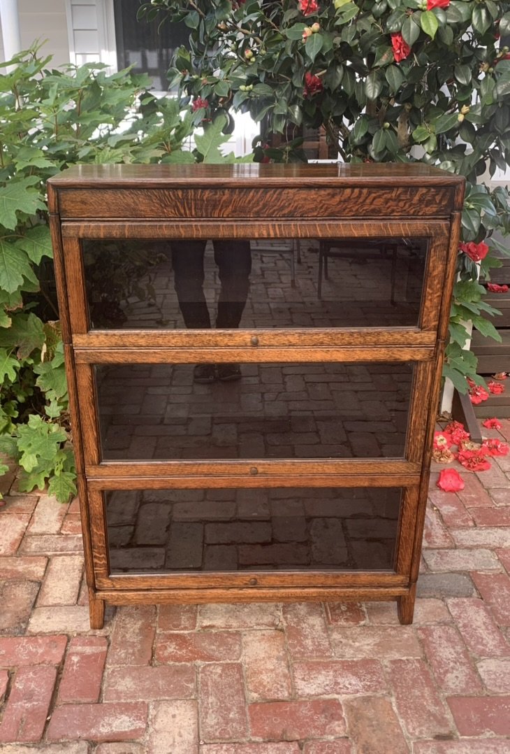 Front view of antique English oak stacking bookcase with three glass-front sections, Globe Wernicke style
