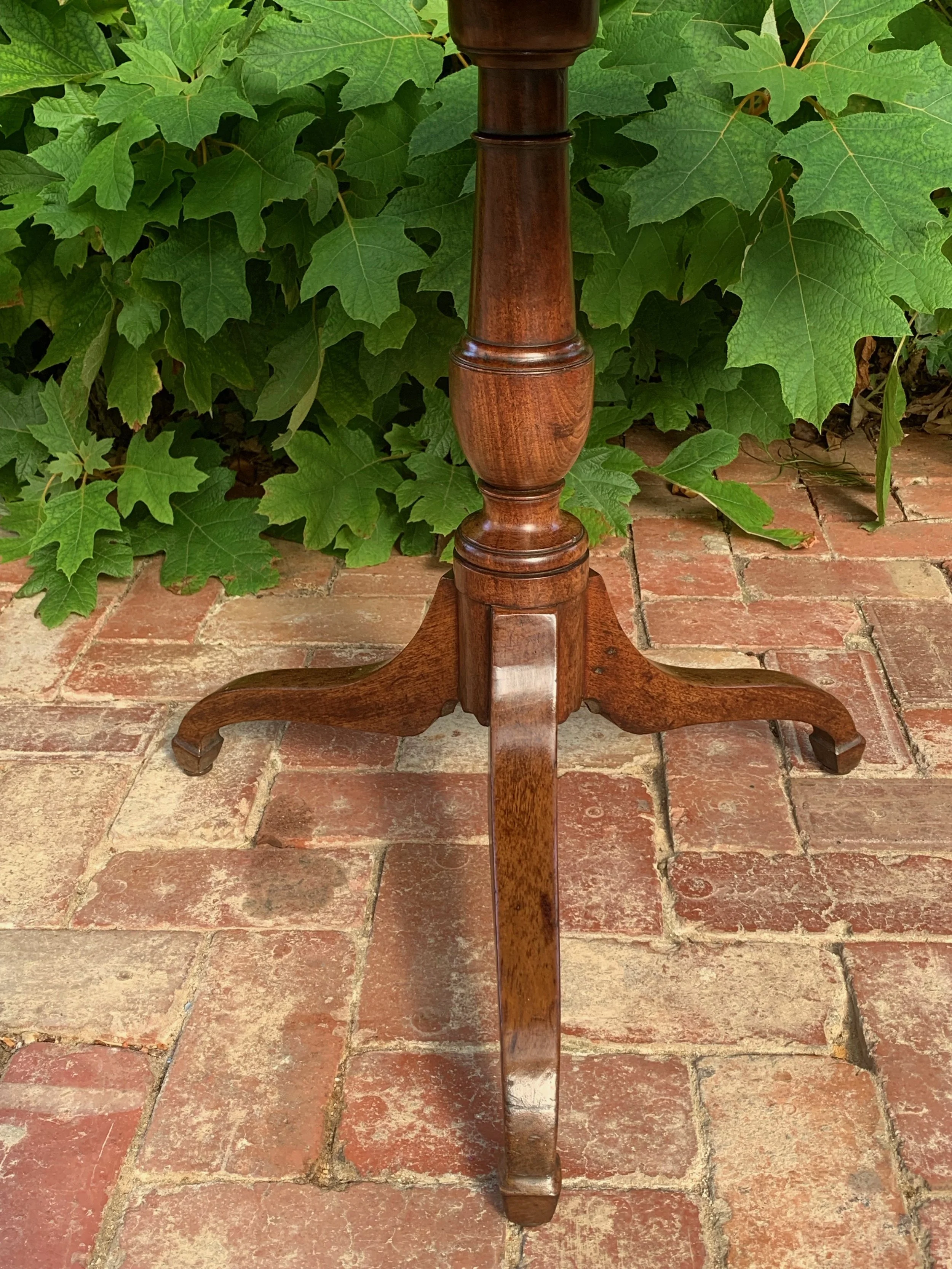 View of urn-turned column and tripod legs of English Georgian tilt-top wine table C.1800-1830 