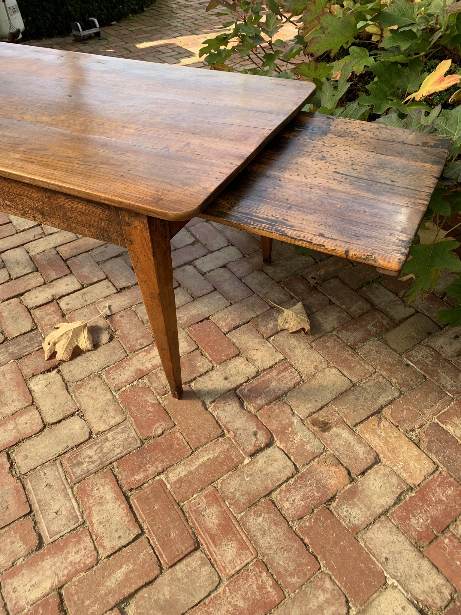 French cherry dining table with pull-out bread board slide extended from side frieze, circa 1840