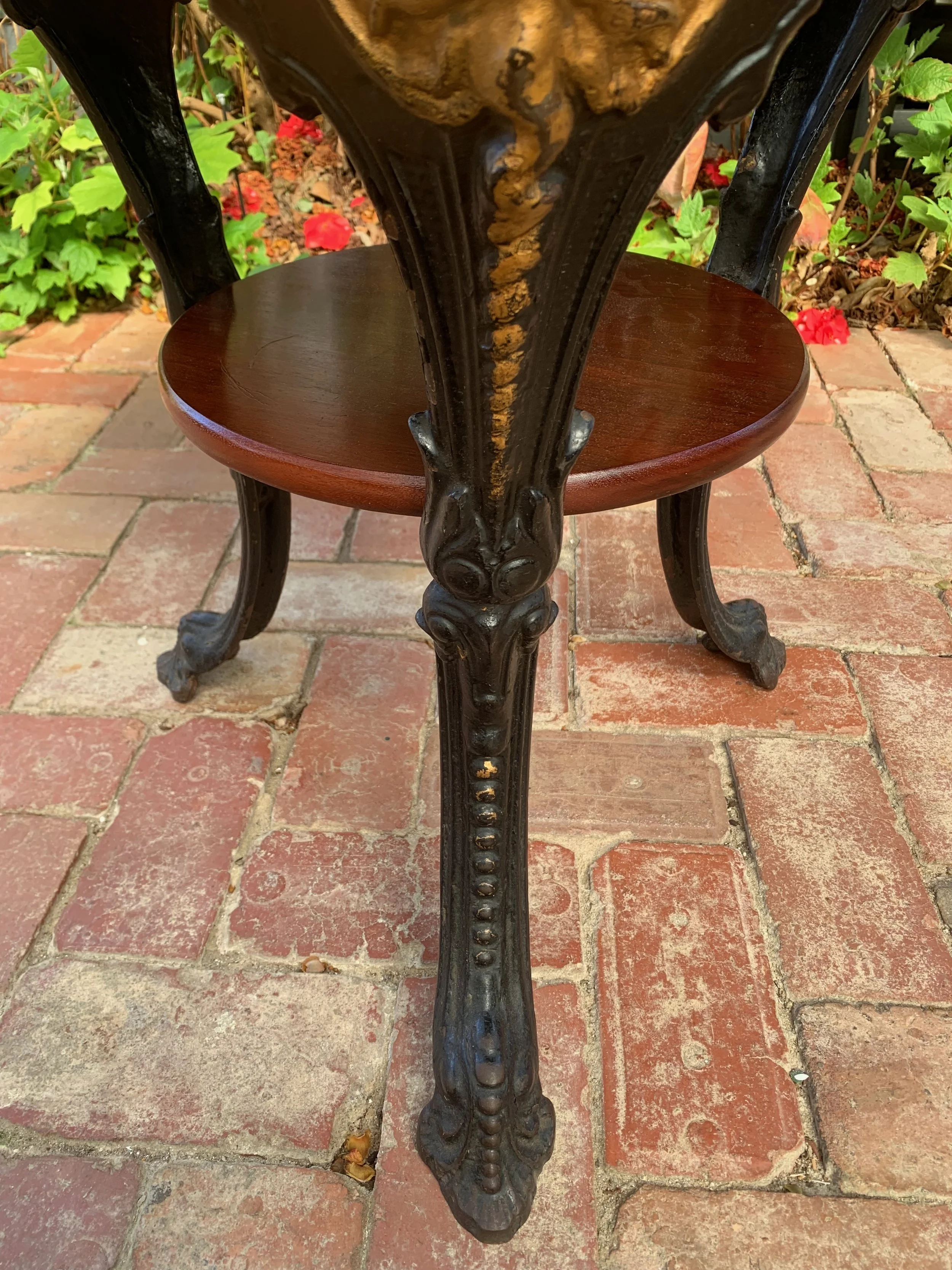 English cast iron pub table mask medallion, gilded faun face, circa 1920, cabriole leg, mahogany undertier