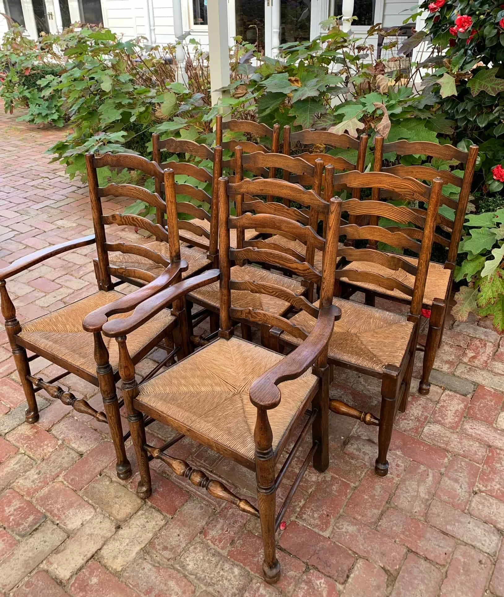 Set of 8 oak and ash wavy ladderback chairs, Lancashire c.1850, two carvers and six side chairs with rush seats