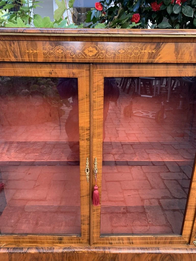 view of string inlay on Victorian figured walnut pier cabinet with glazed double doors single shelf and ormolu mounts