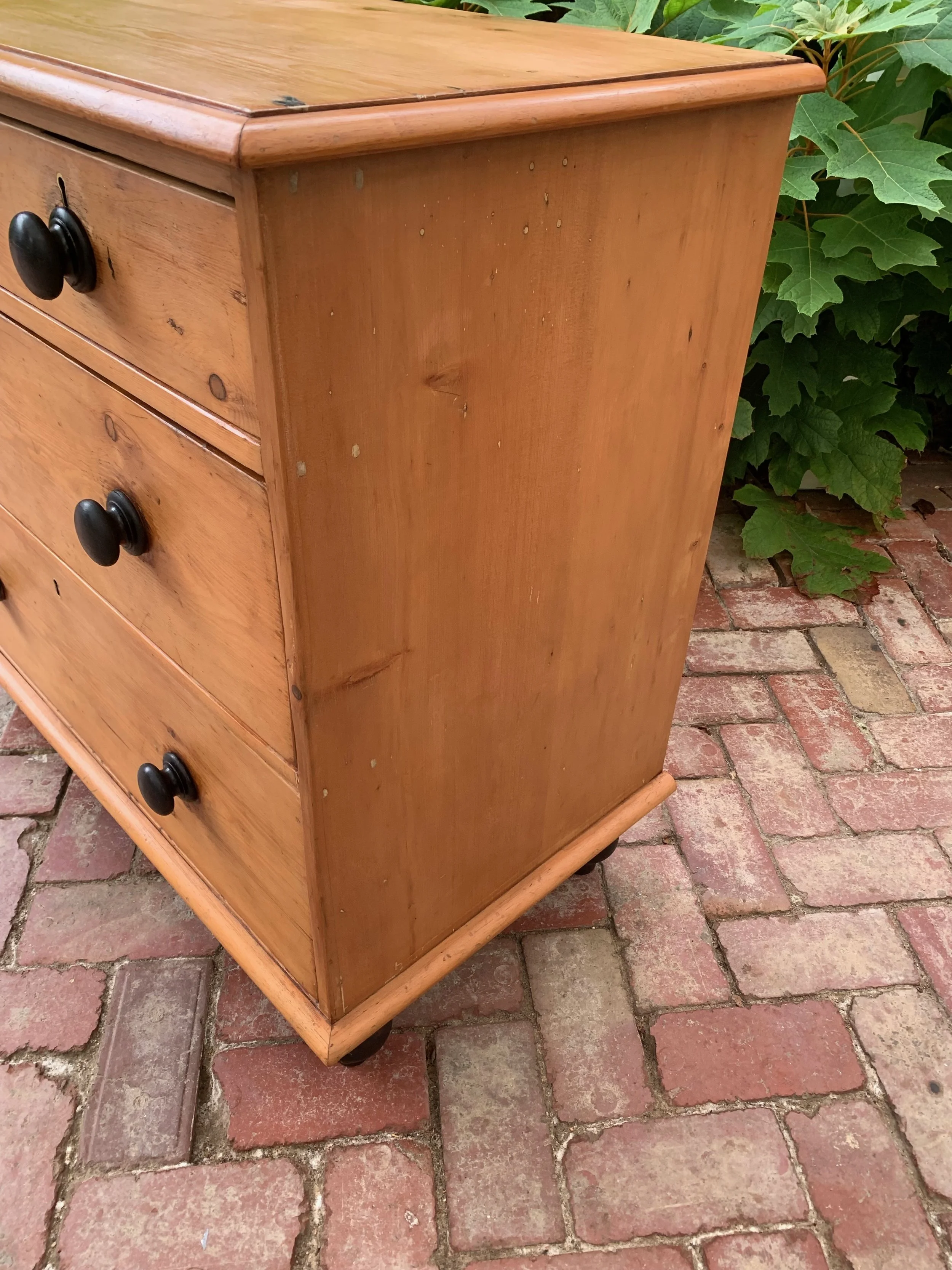 Side view of antique country pine chest of drawers