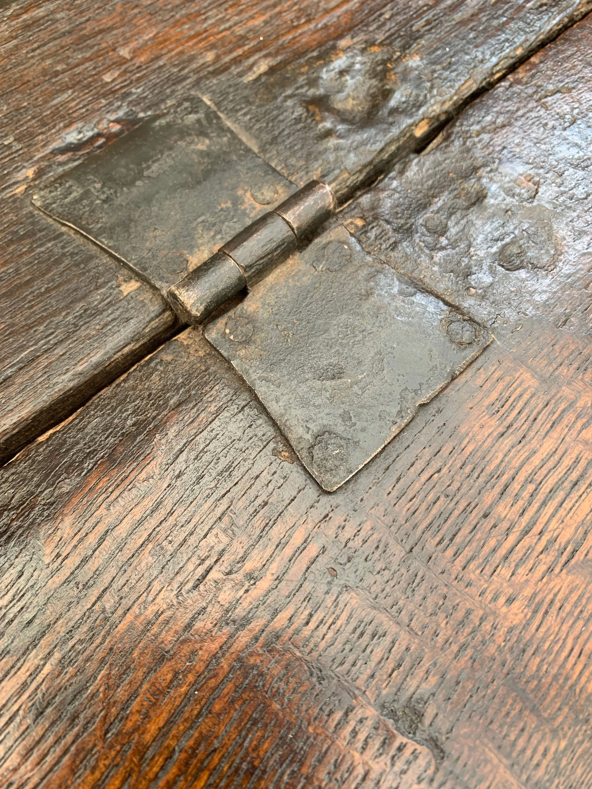 Close up of original wrought iron seat hinge on welsh oak box settle c.1720