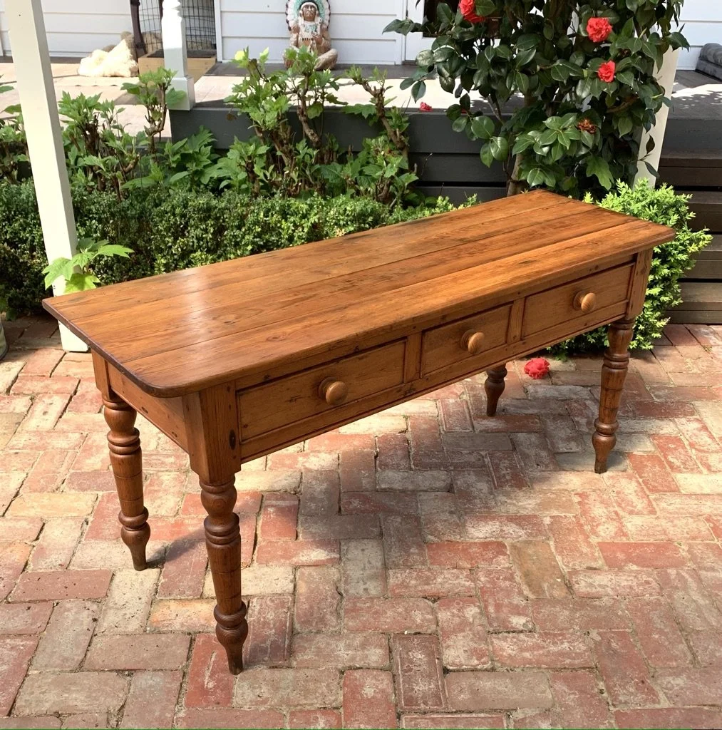 angled view of victorian three drawer country pine console table