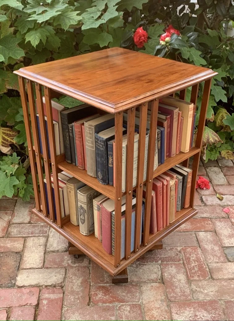 Antique English walnut revolving bookcase Edwardian filled books front view