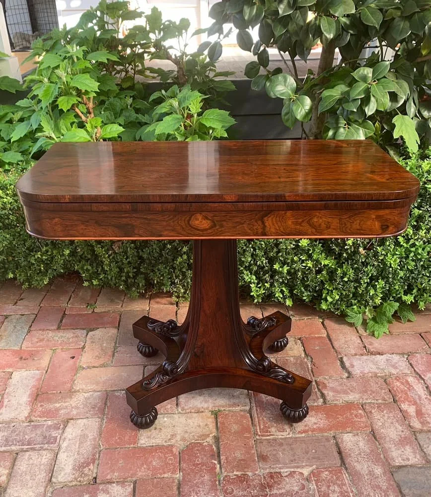 William IV rosewood card table with figured swivel top on carved pedestal base