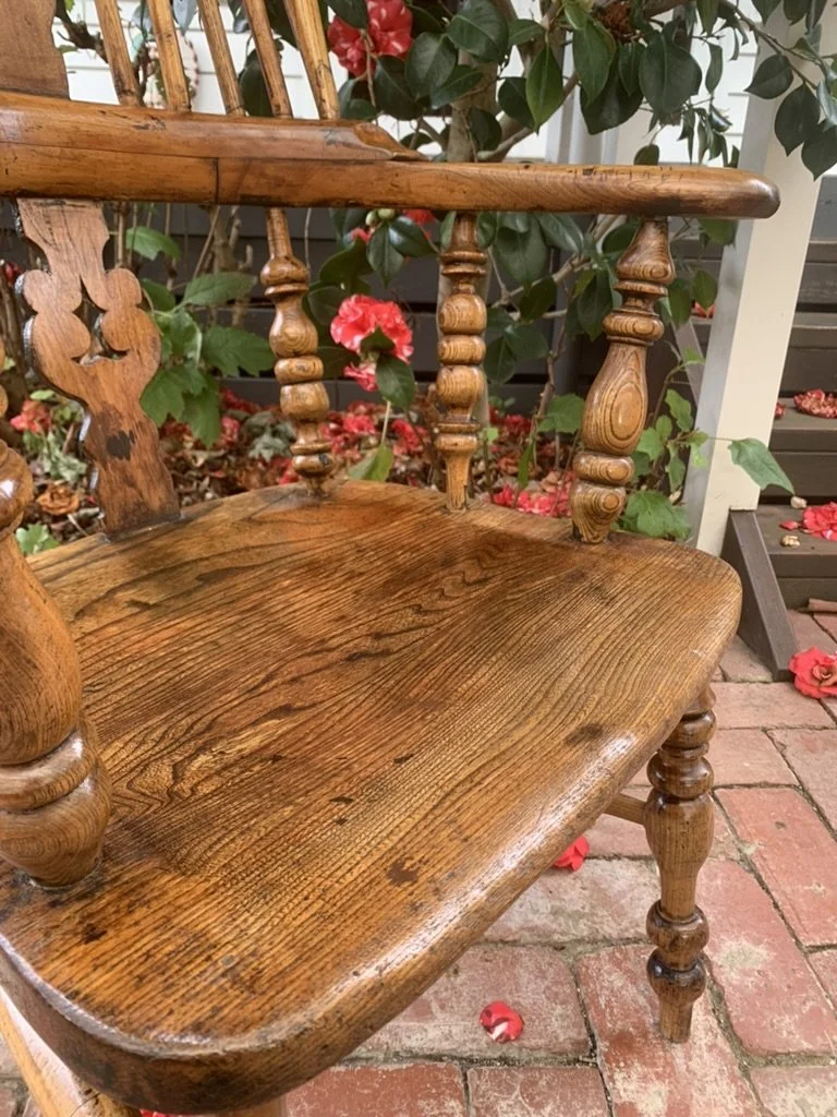 Close-up of shaped elm seat and pierced oak splat on antique broad arm Windsor armchair