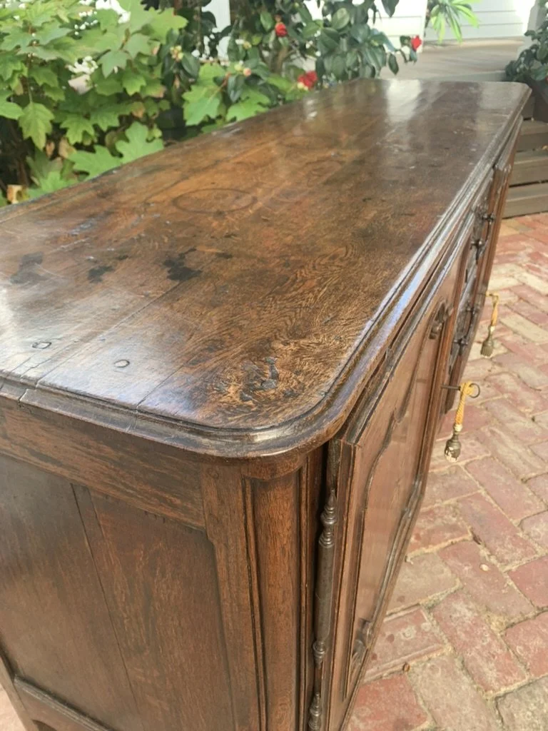 Rounded top corner detail of antique French oak sideboard showing original patina, c.1760