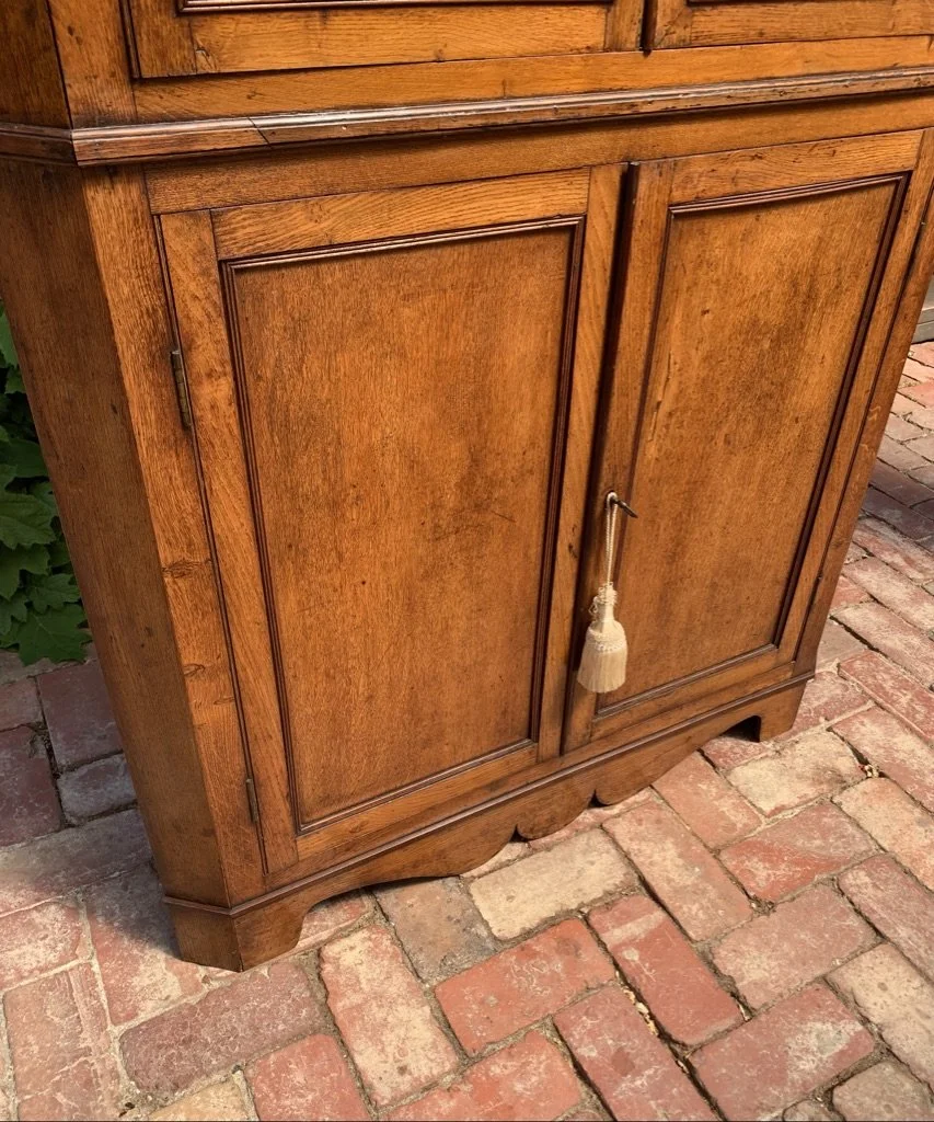close up of lower section of georgian oak corner cabinet
