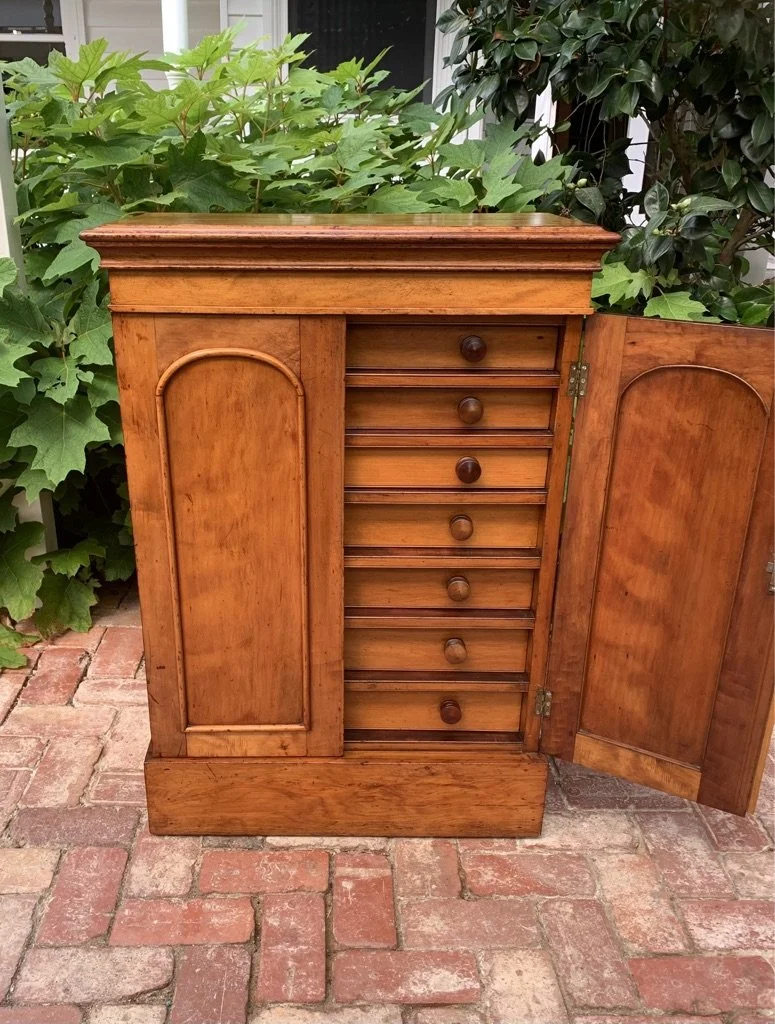 Victorian cedar satin walnut collector's cabinet one door open showing seven shallow drawers with turned knobs, 19th century
