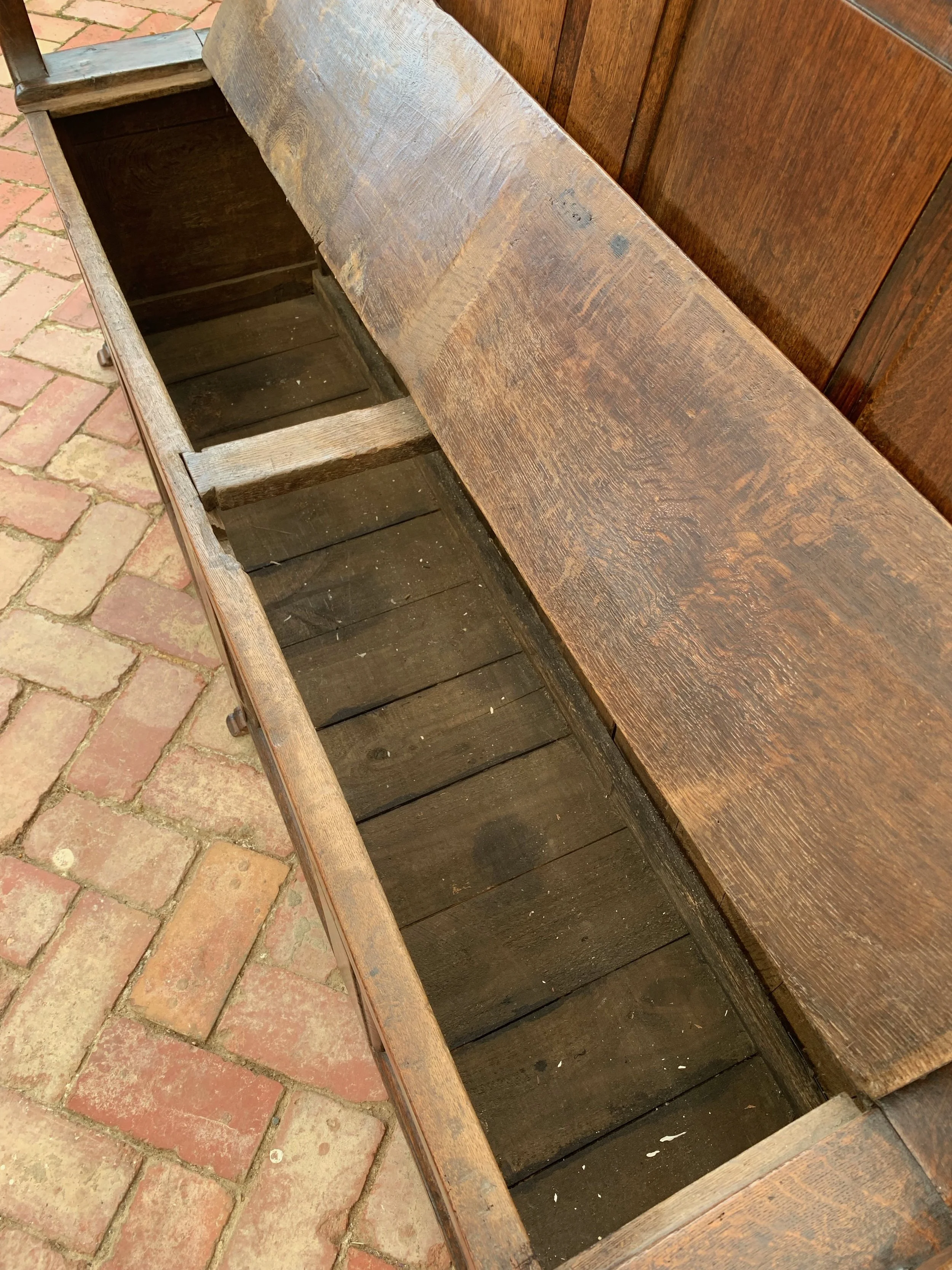view inside storage compartment of welsh oak box settle C.1720