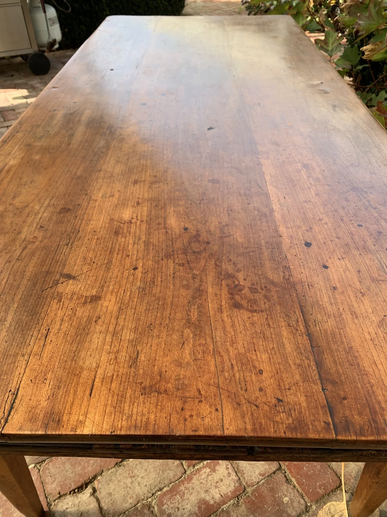 Overhead view of antique cherry wood table top showing grain, colour and age-appropriate wear