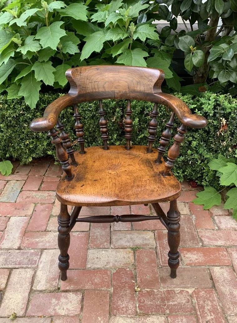 19th century elm pub chair, smoker's bow armchair with shaped saddle seat and turned spindle back, front view