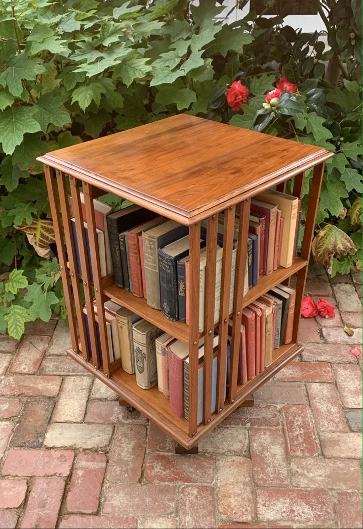 Antique walnut revolving bookcase Edwardian c.1910 filled with books two tiers