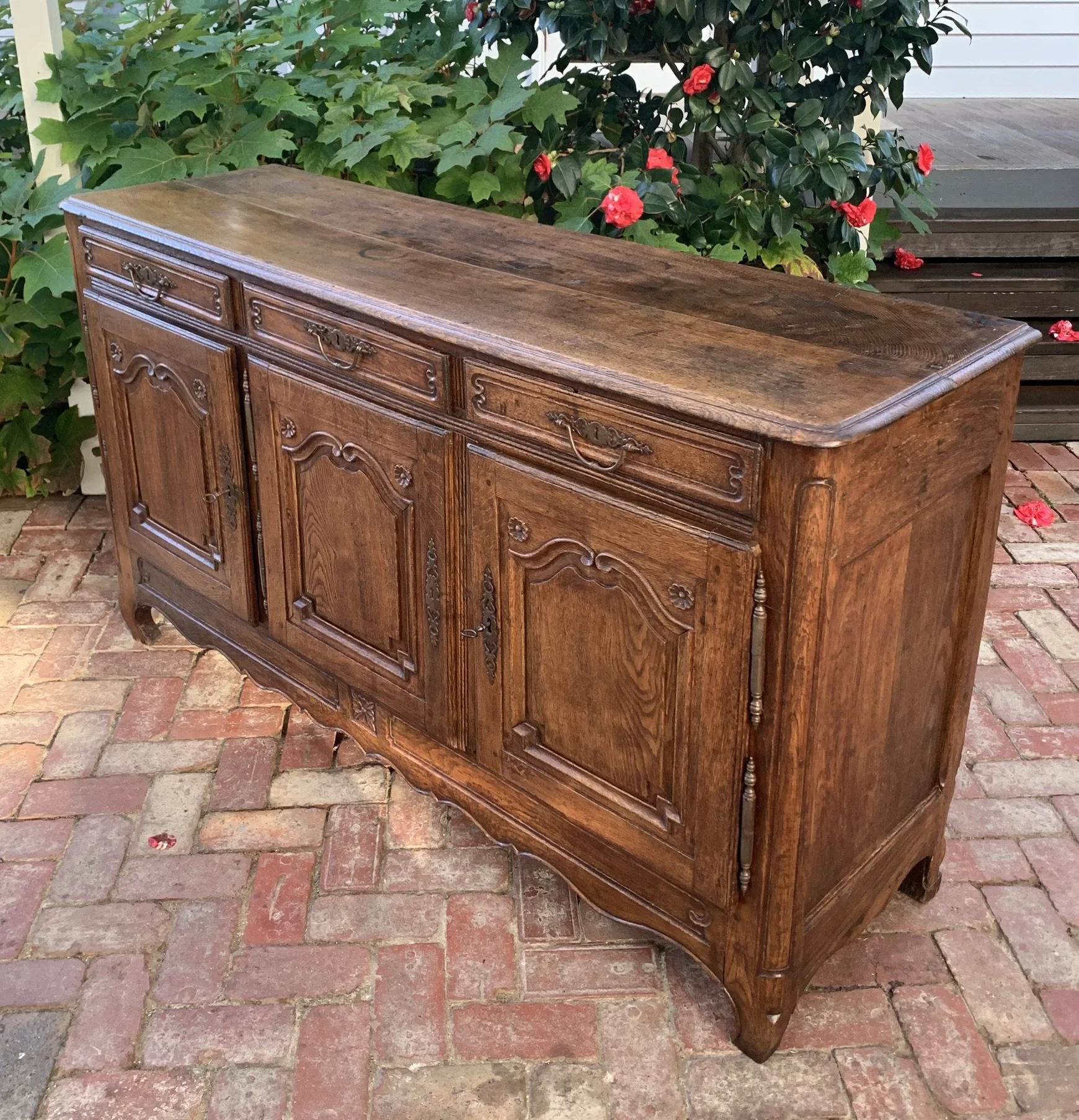 Angled view of French oak enfilade sideboard, c.1740-1760, showing depth and turned column detailing