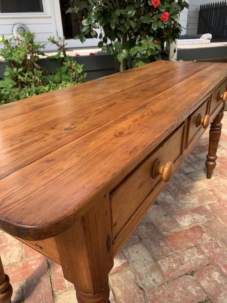 view looking down the length of the top of antique country pine console table