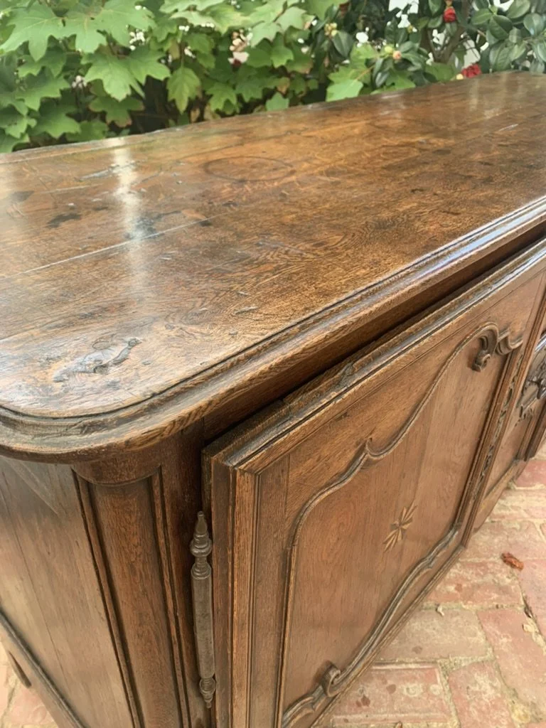 Corner detail of French provincial oak sideboard top with visible drawer and door joinery