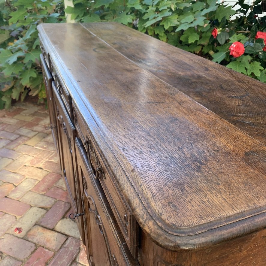 Oak top surface detail on 18th-century French provincial buffet, showing plank construction and age patina