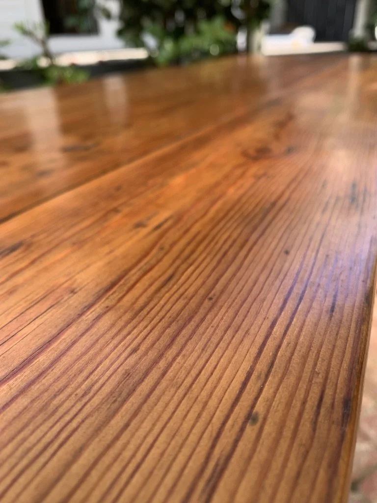 close up of pine timber grain of top of antique country pine  console table