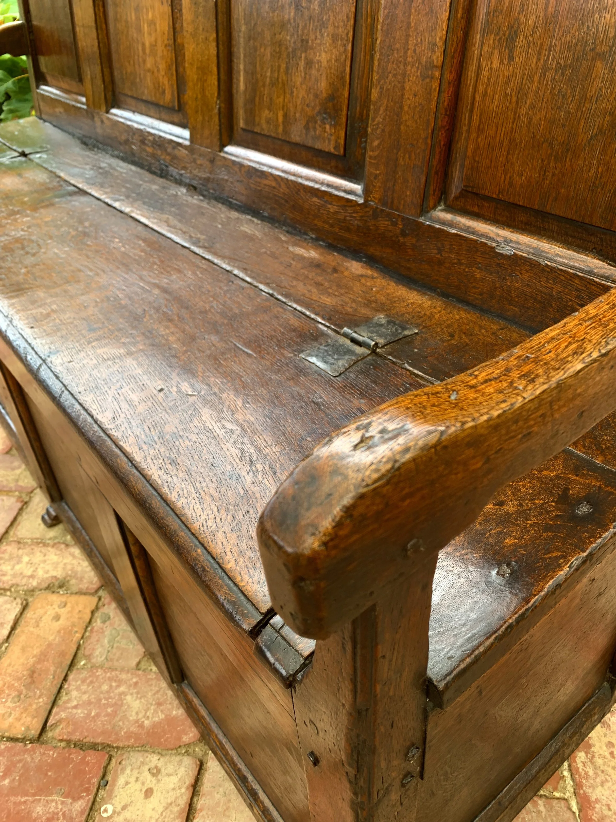 close up of arm rest and seat on welsh oak box settle C.1720