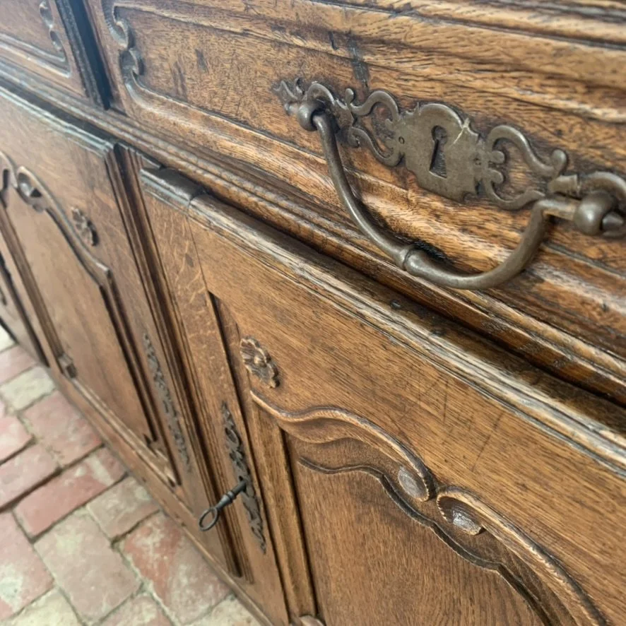 Original iron escutcheon and bail handle hardware on antique French oak buffet, c.1750