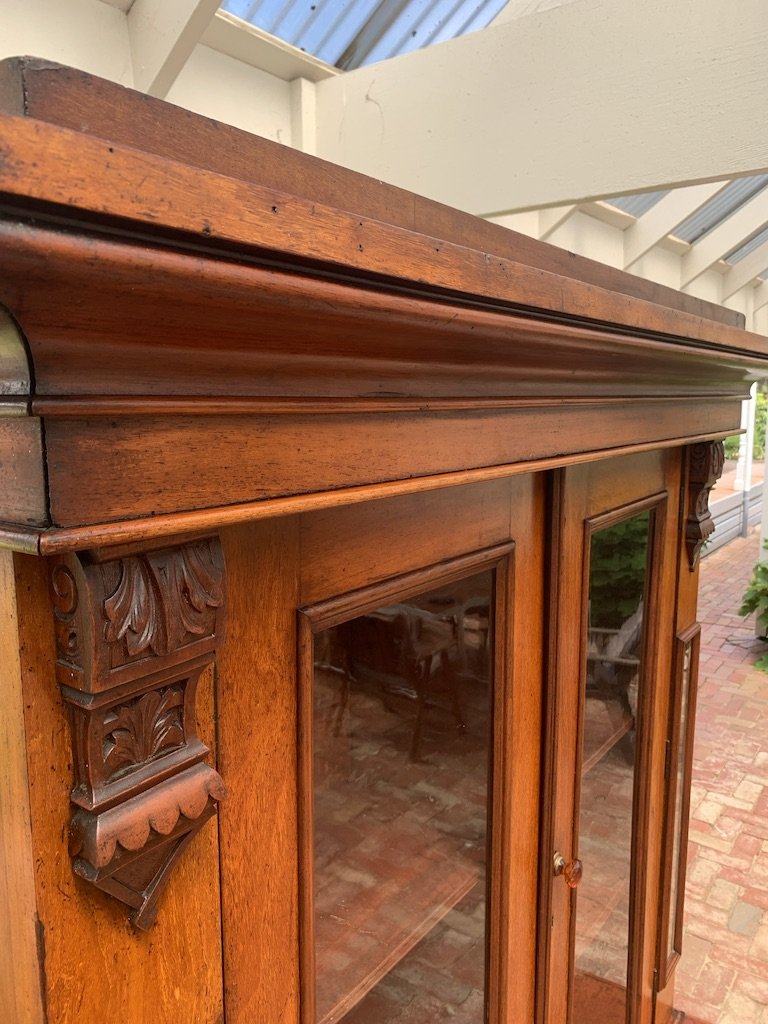 close up of stepped cornice on australian colonial cedar boookcase