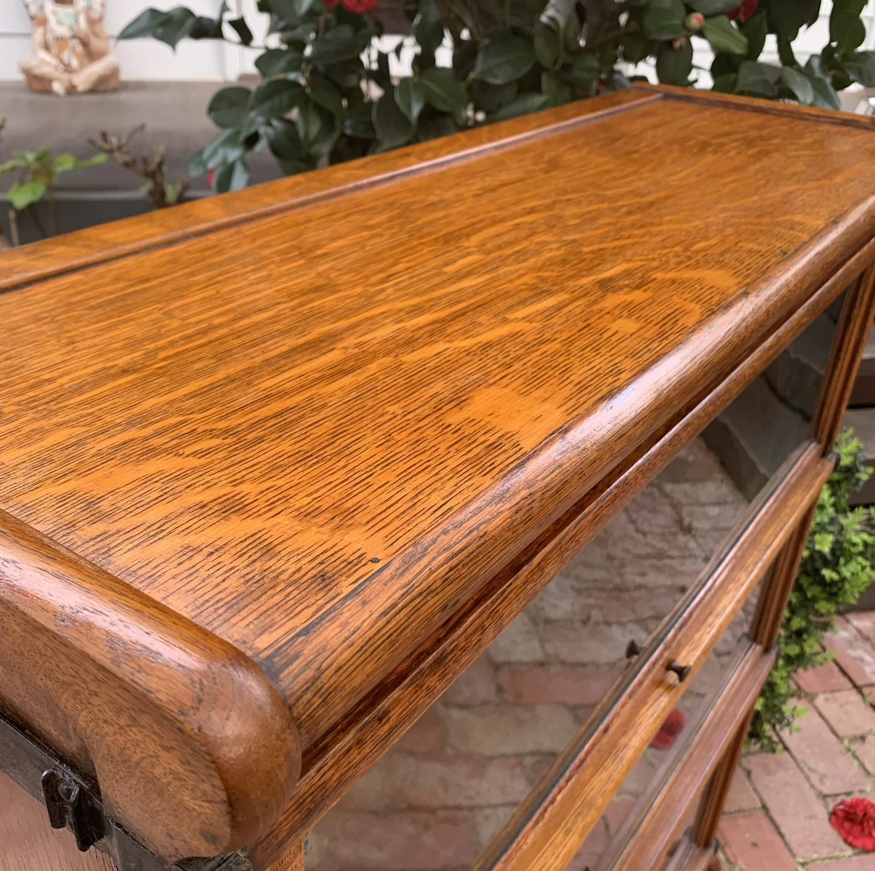 Close-up of golden oak grain and moulded top edge, antique Globe Wernicke barrister bookcase, C.1910