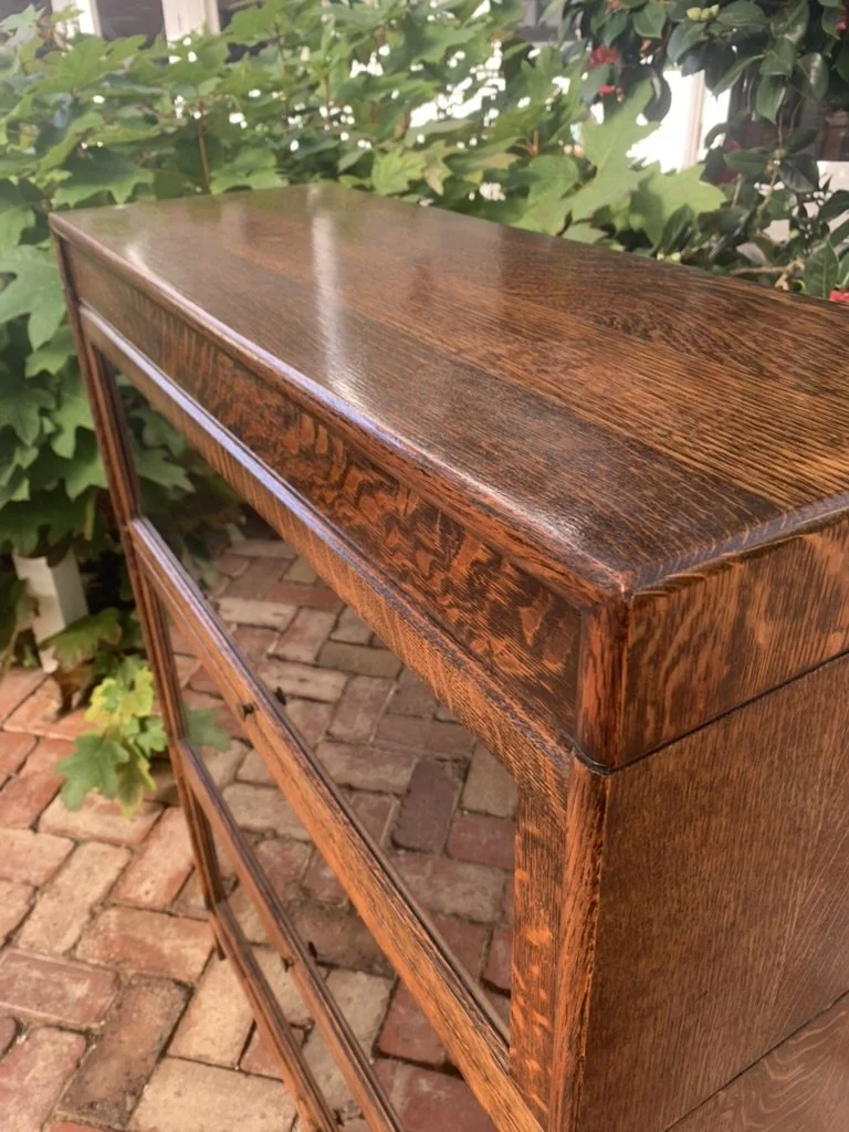 Close-up of quarter-sawn English oak top corner on antique barrister bookcase, ray fleck figure and moulded edge