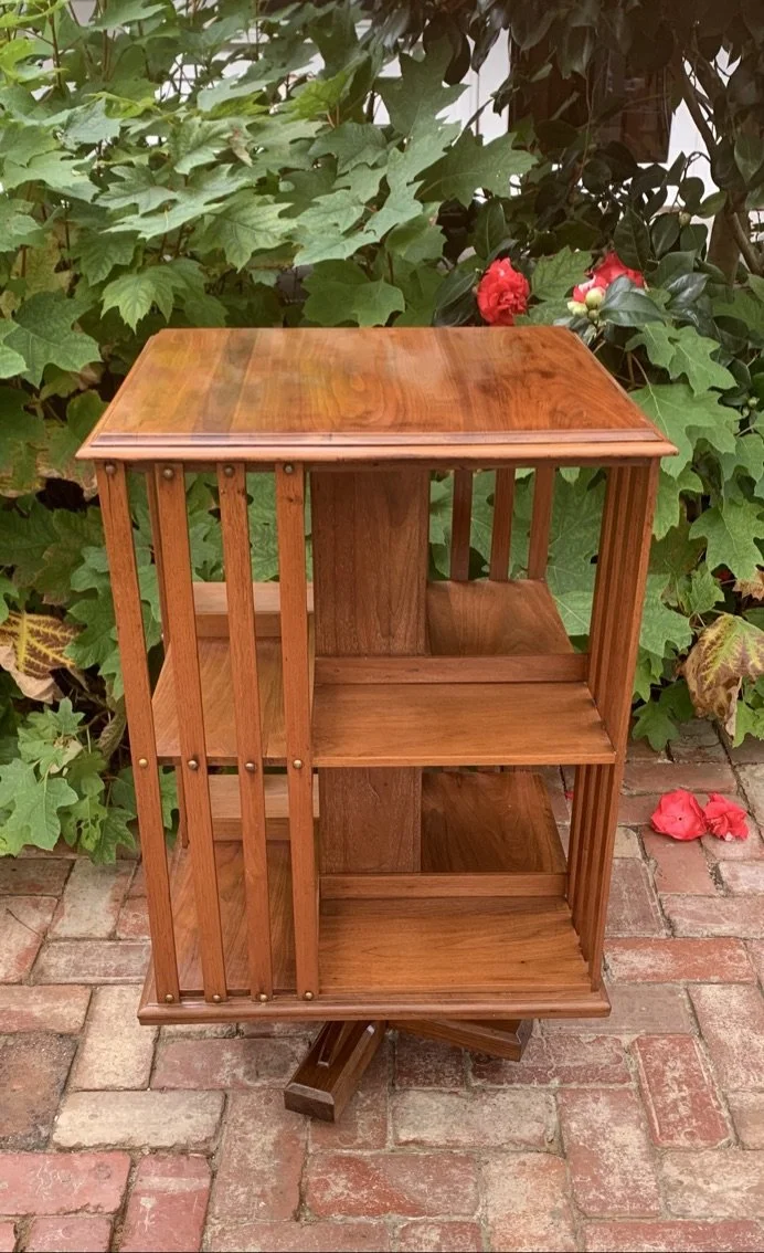 Side view Edwardian walnut revolving bookcase c.1910 cruciform base castors