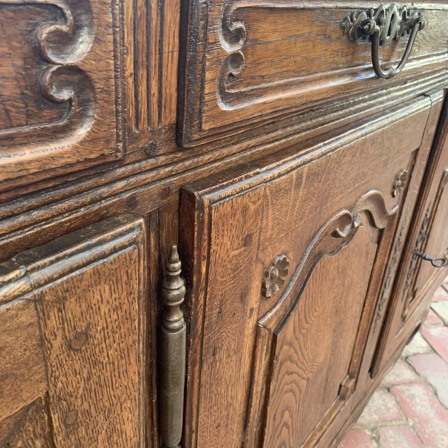 Carved drawer front and turned mullion detail on 18th-century French provincial oak buffet