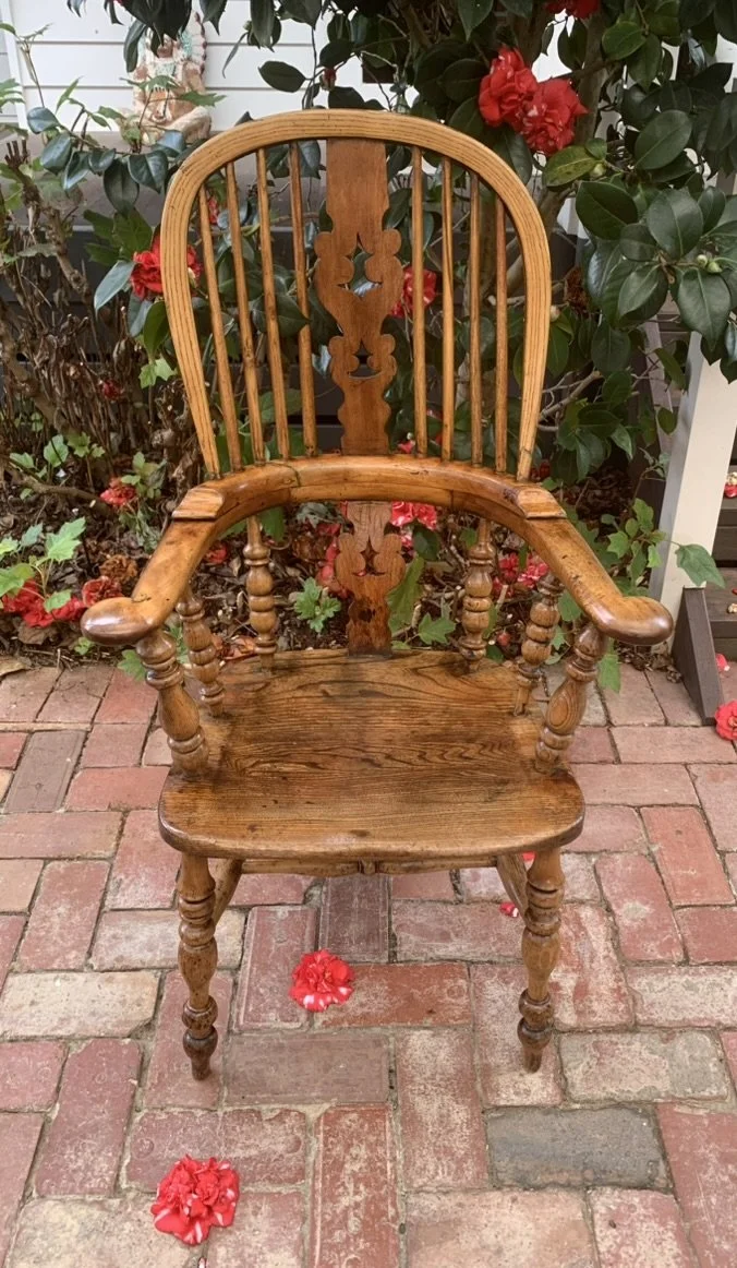 Front view of late Victorian oak and elm Windsor armchair with pierced fretwork splat