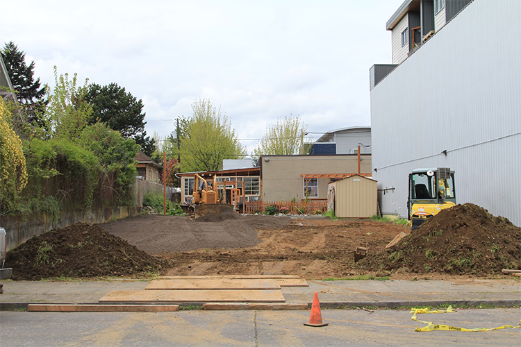 Parking lot with dirt and construction trucks
