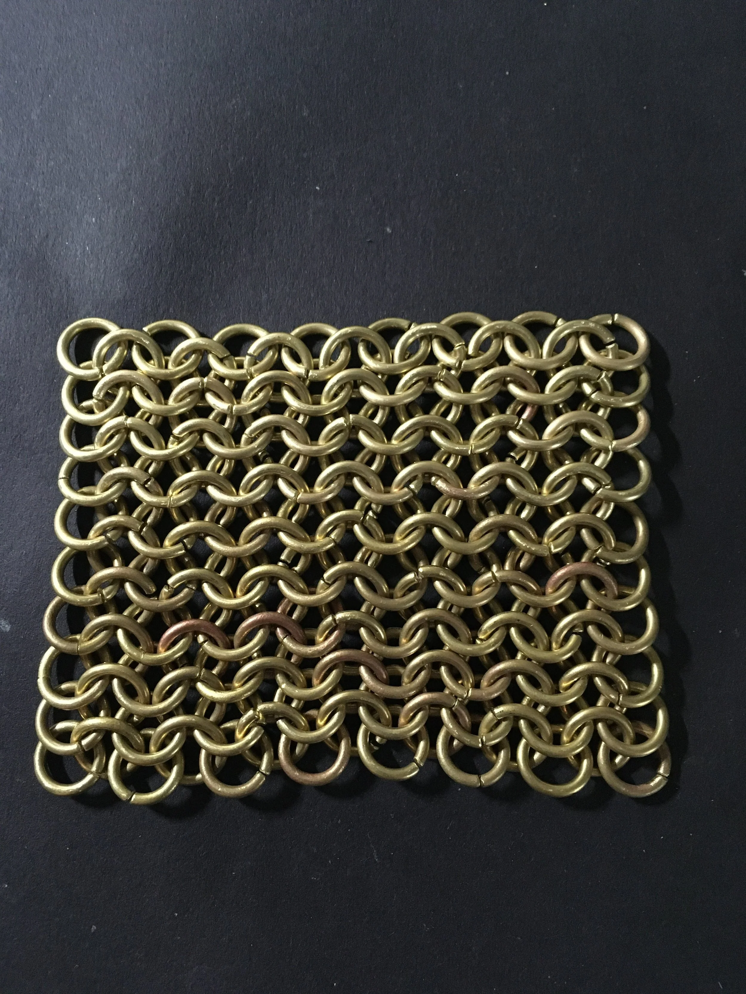 About 143 brass jump rings = 3" X 3"