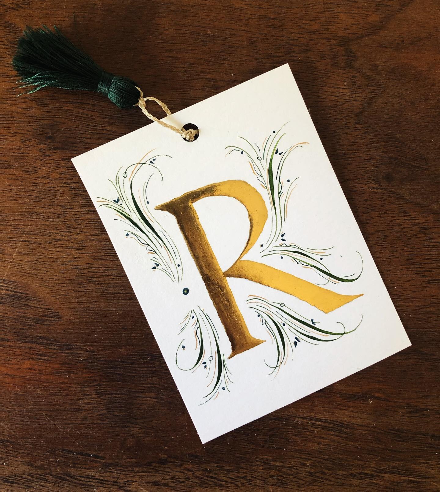 Now that this has made it to its recipient, I can share this fun project!! Gilded &ldquo;R&rdquo; initial bookmark, (#realgold 23k gold 😍) and tassel (made by me👋🏼). Flourishing with mixed watercolors of deep emerald and deep teal, paired with som
