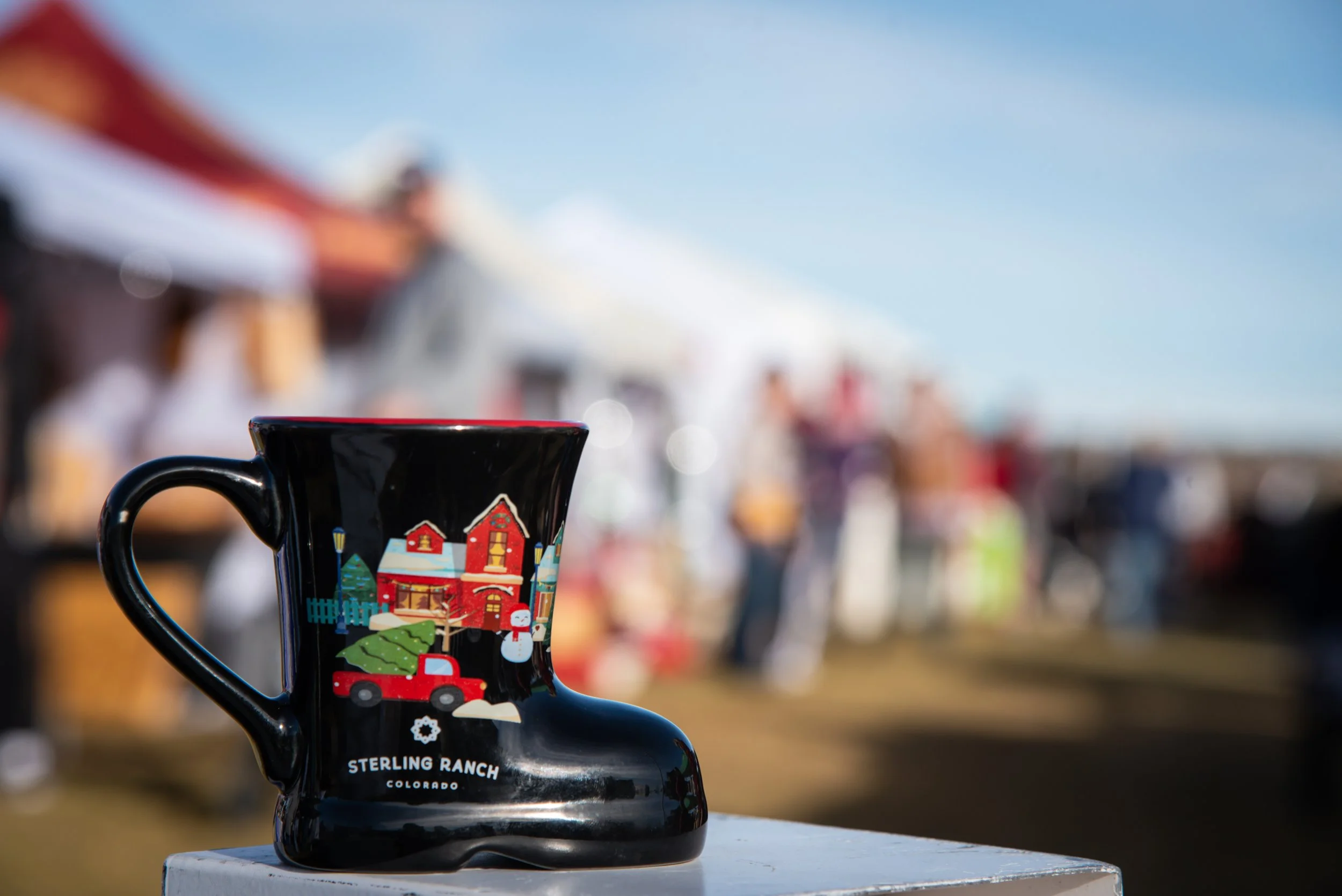 Residents enjoying holiday market community event in a Douglas County neighborhood with branded mug, captured by a professional community event photographer