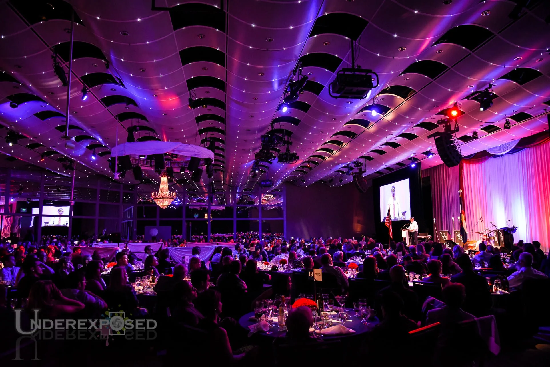 Low light event photography at a Denver corporate awards ceremony in downtown hotel ballroom