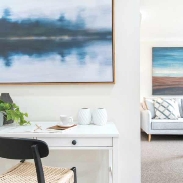 Office area with white desk and abstract blue painting designed by Kristin Roser