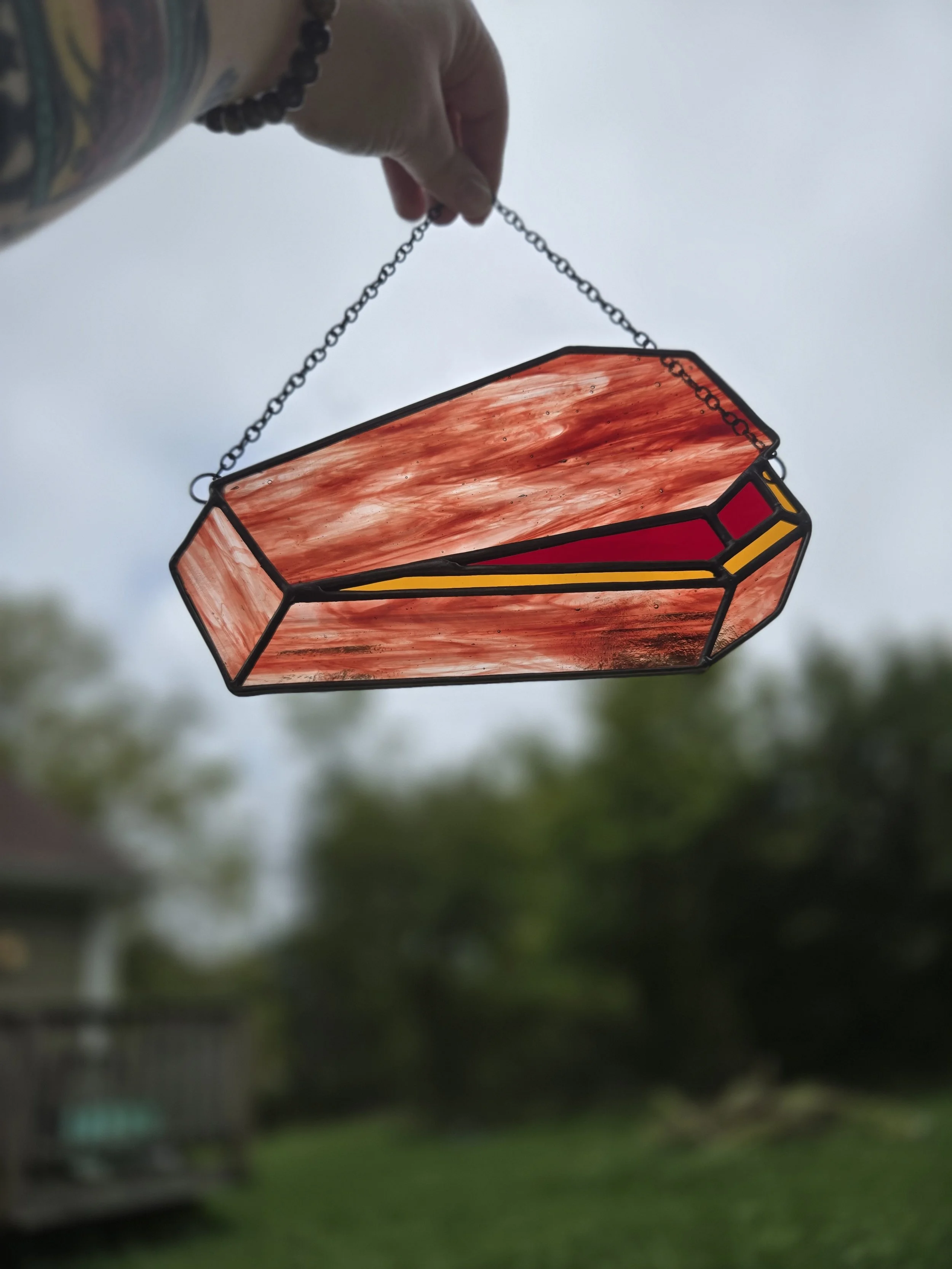 "open up" coffin stained glass suncatcher, streaky brown