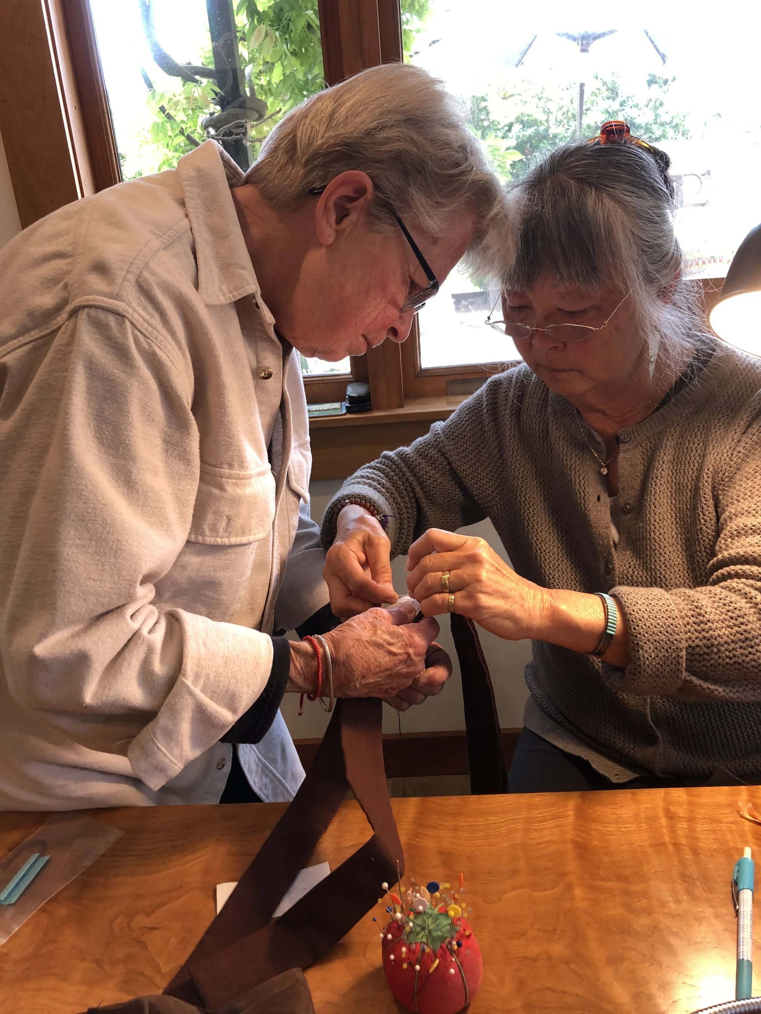 Sue and Sandy sewing pin stitch on rain stitch rakusu Mid May 2021.jpg
