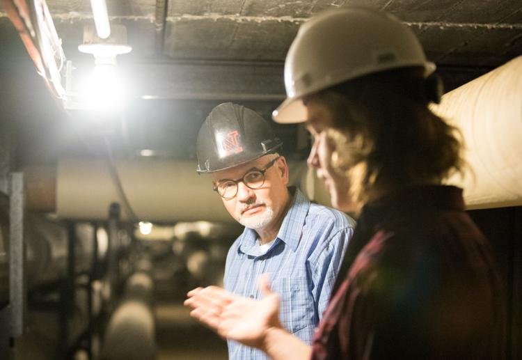 Stefan Newbold (left), engineering manager for the UNL Department of Facilities and Construction, explains the function of the underground tubes to reporter Jake Stahlnecker on March 8, 2018, in Lincoln, Nebraska.